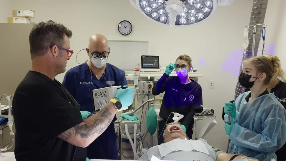 Dr. Lillis and his team working with a patient in the operatory