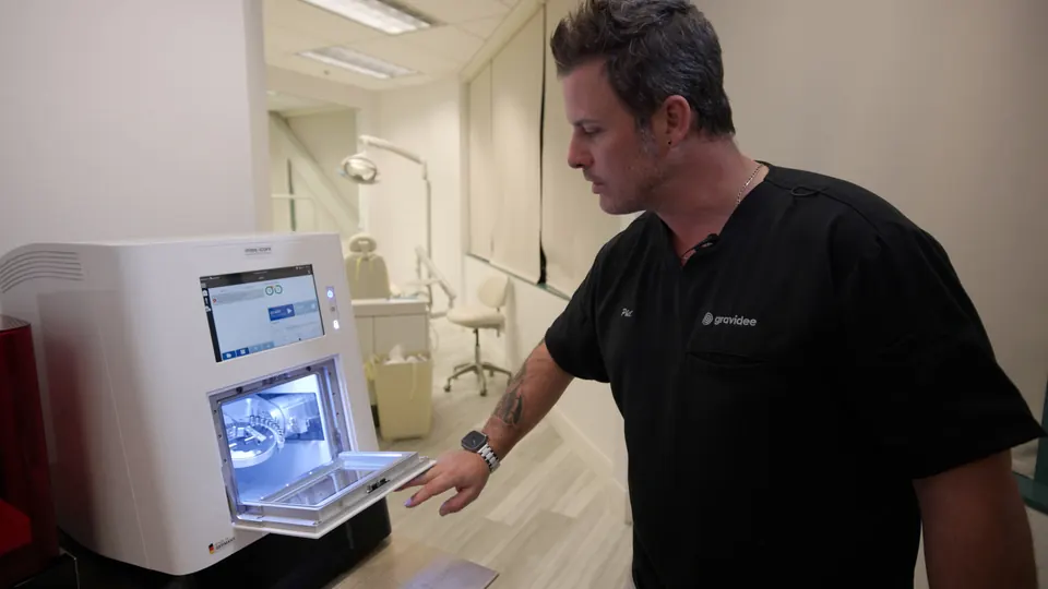 Dr. Lillis at the 3D printer in the in-office lab
